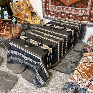 Detail of bohemian geometric woven blanket with tassel edges for outdoor camping and home