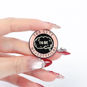 Cartoon enamel brain brooch with Too Cute To Be Neurotypical text in pink and gold