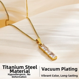 Macro detail of titanium steel necklace with triple square cubic zirconia on beige silk
