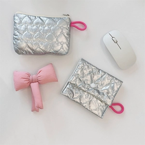 Close-up of silver quilted heart pouches with metal finish and pink clip-on loops
