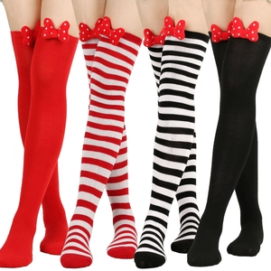 Detail view of thigh-high striped socks with red bows for festive holiday party costumes
