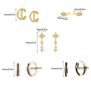 Set of gold punk earrings featuring celestial charms and black enamel details with dimensions