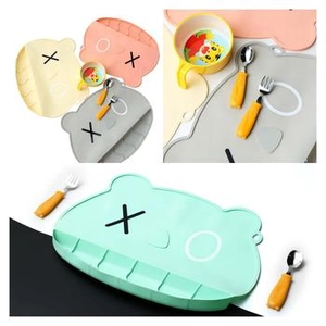 Detailed view of KAWS-inspired silicone placemat with stainless steel cutlery set