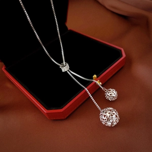 Elegant long silver stainless steel necklace featuring double hollow ball pendant design
