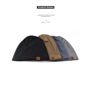 Flat lay of knit beanies in four colors with premium leather logo patch detail