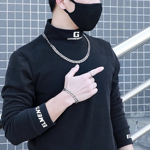 Close-up of a silver-toned urban hip-hop style Cuban chain necklace and bracelet set