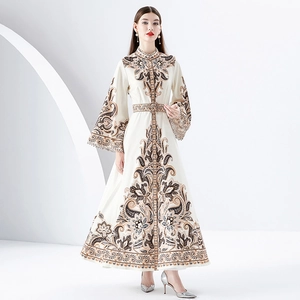 Vintage bohemian floral maxi dress with stand collar and flared sleeves on white backdrop