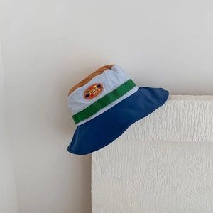 Detail of color-block sun hat with leather patch on breathable quick-dry fabric