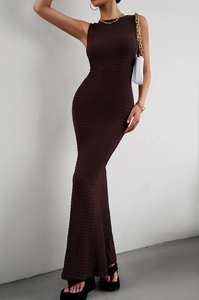 Detail of a dark brown sleeveless knitted maxi dress with a textured fishtail hemline