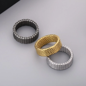 Detailed view of woven texture rings in gold silver and black steel finishes