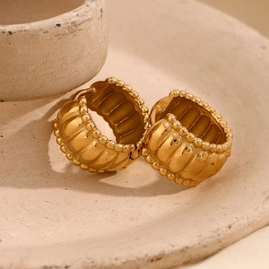 Macro view of vintage 18K gold plated twisted hoop earrings with textured finish
