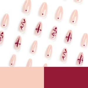 Almond shaped press-on nails with snake pattern and cross designs in pink and red