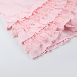 Detailed close-up of pink layered ruffles and delicate lace textures on a bodysuit