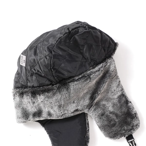 Detailed view of winter trapper hat with gray faux fur lining and size 58 label