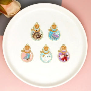 Detailed view of enamel marine charms with octopus and jellyfish in bottle shapes
