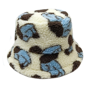 Plush lamb wool bucket hat with stylish blue and brown cow print pattern for winter warmth