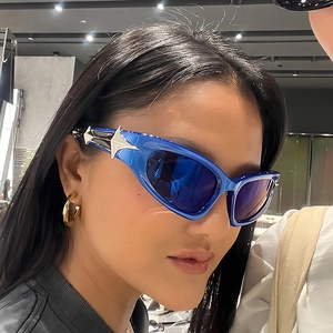 Blue Y2K cat-eye sunglasses with silver star metal detail on futuristic frames