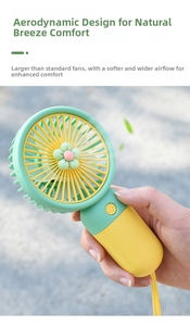 Close-up of a green and yellow portable mini fan with a pink flower and wrist strap