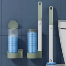 Wall-mounted toilet brush storage base with handle and blue cleaning head refills