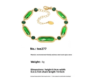 Detail of vintage gold-plated stainless steel bracelet with green glass stone accents