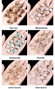 Macro shot of assorted raw crystal pendants with gold plating for DIY jewelry making