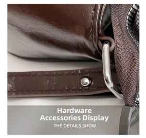 Macro shot of polished dark brown leather with silver metal ring and zipper detail