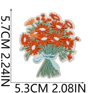 Detail of flower bouquet embroidery patch featuring orange daisies and green stems