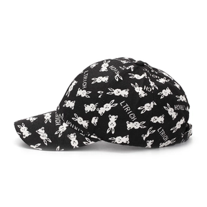 Detailed view of black baseball cap with white rabbit patterns and metal buckle
