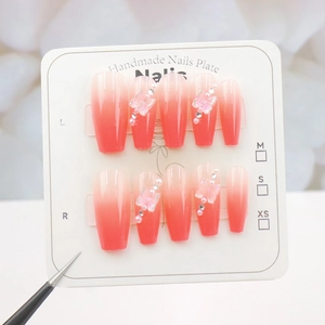 Macro detail of handmade peach gradient press-on nails with 3D bows and pearls