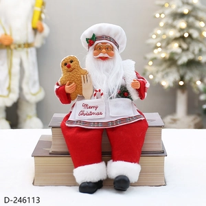 Close-up of Santa chef figurine with Merry Christmas apron and gingerbread man accessory