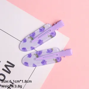 Detail of purple floral duckbill hair clips with dimensions 6.1cm by 1.8cm