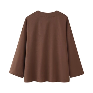 Detailed flat lay of brown long sleeve linen top with round neck and dropped shoulder