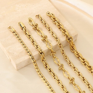 Minimalist 18K gold stainless steel Cuban and twist chain bracelets on a stone display