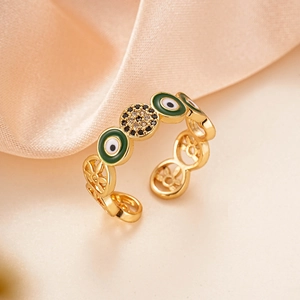 Macro shot of 18K gold plated evil eye ring with green enamel and clear cubic zirconia stones