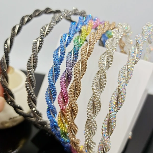 Detail of six colorful rhinestone headbands featuring elegant spiral weave crystal design