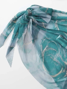 Detail of turquoise marble print sarong with sheer texture and side-tie design