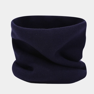 Detail of navy blue knitted neck warmer with fine ribbed texture for winter warmth