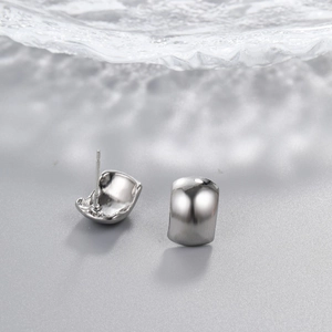 Detailed back and front view of silver teardrop earrings with high-polish metallic finish