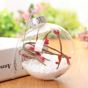 Detail view of 8cm clear Christmas ball ornament with red berries and snow inside