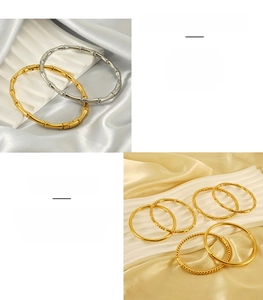 Detail showing bamboo texture and bead design on stainless steel bracelets in gold and silver