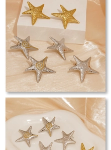 Detail of starfish stud earrings with hammered metal texture in gold and silver finish