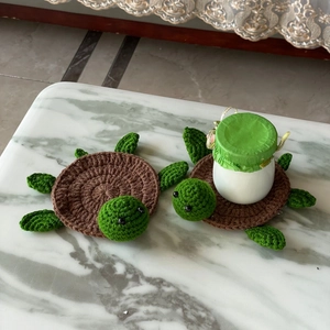 Handmade crochet turtle coasters set of two on marble table for home decor