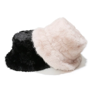 Detail view showing the soft faux fur texture of black and pink bucket hats.