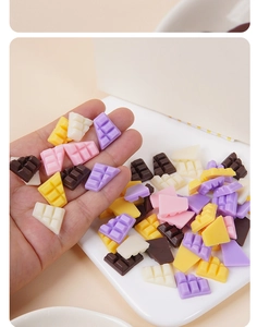 Macro view of miniature resin chocolate charms in pastel colors for DIY crafts decoration