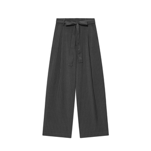 Detailed view of dark grey wide-leg trousers with white pinstripes and waist tie