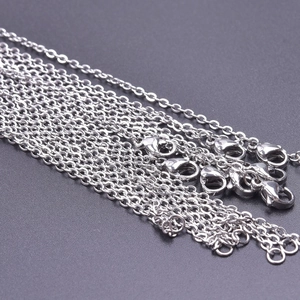Detailed close-up of 2mm silver stainless steel cross chains with lobster clasps for DIY jewelry
