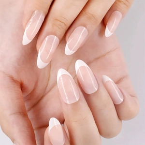 French tip press-on nails in oval shape with nude base and white tips on hands