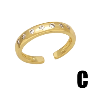 Detail of gold adjustable open ring featuring seven sparkling round zircon stones