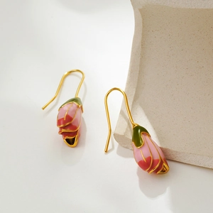 French vintage pink tulip enamel drop earrings with gold hooks on a stone display