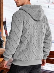 Macro view of grey fleece hoodie featuring textured diamond pattern and warm ribbed cuffs